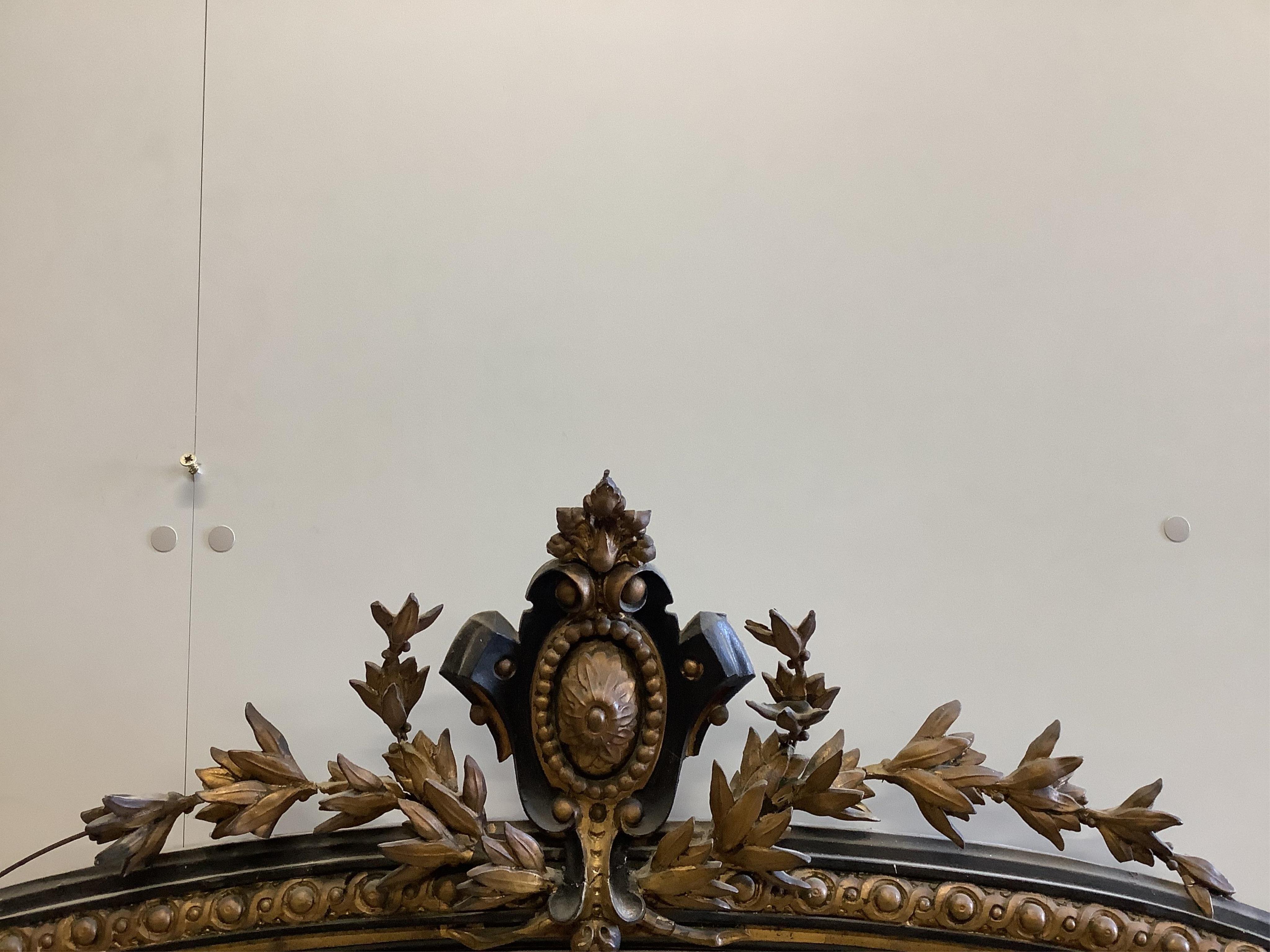 A large Victorian Rococo style giltwood and composition overmantel mirror, width 152cm, height 178cm. Condition - poor to fair